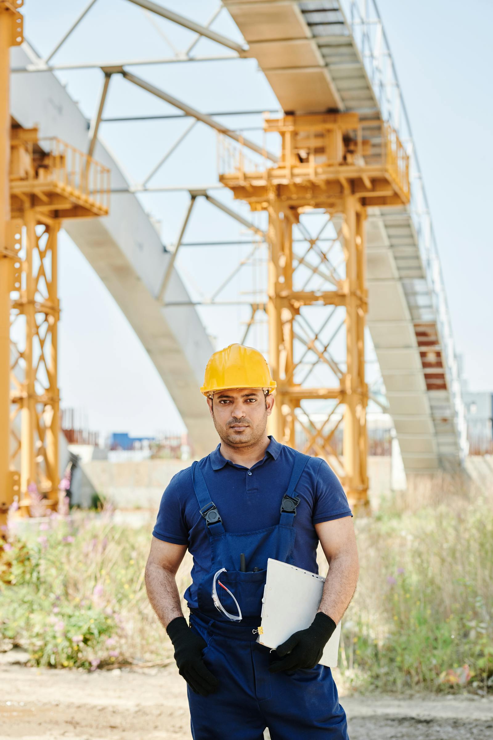 Engineer holding a clipboard while planning work on a construction site