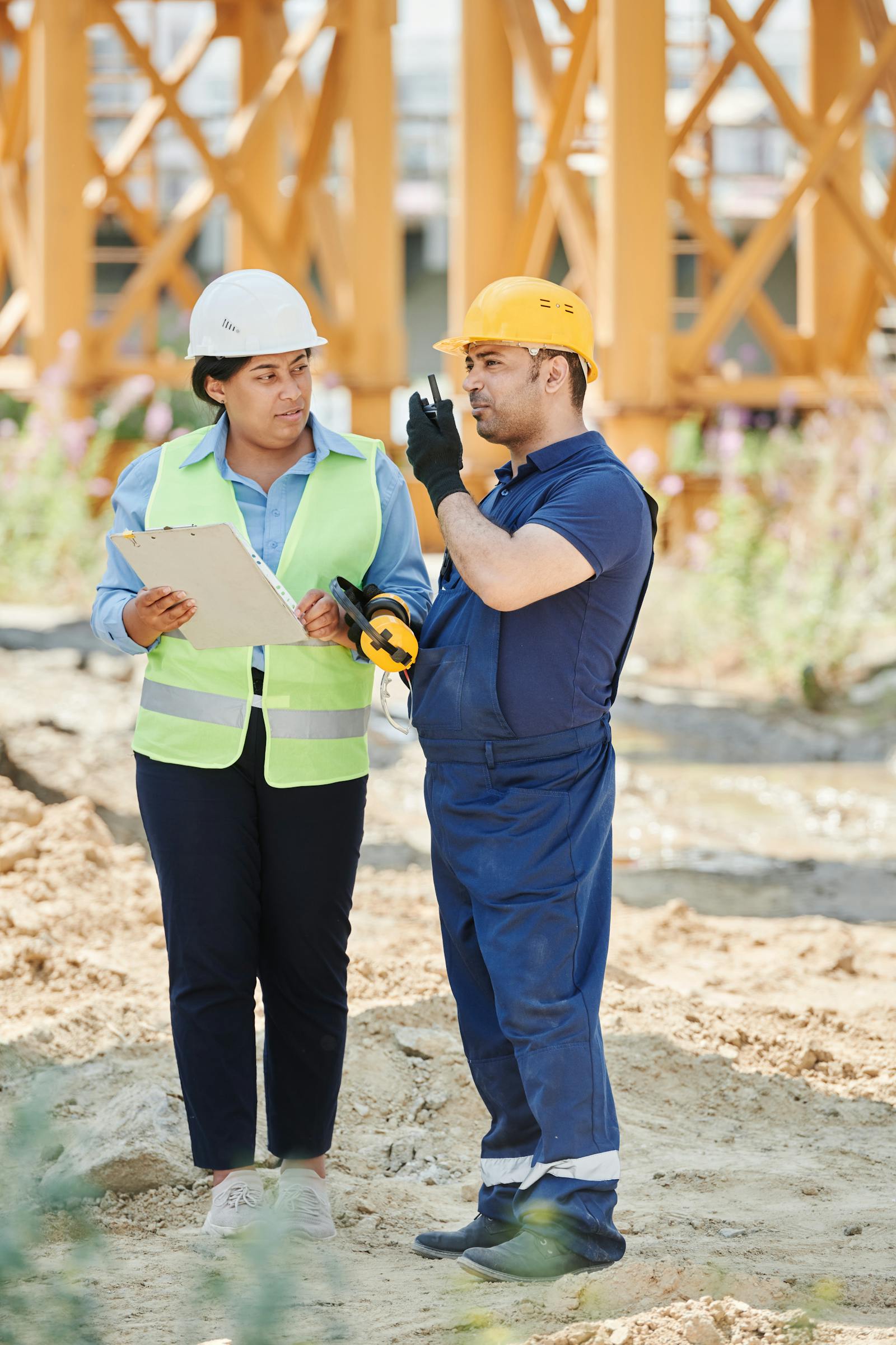 Engineers reviewing construction plans on site